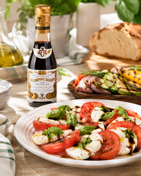 Giusti 2 Gold Medals balsamic vinegar served with Caprese salad and grilled vegetables