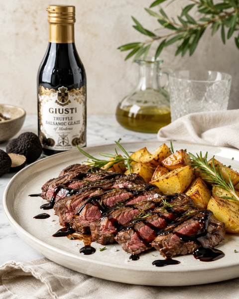 Giusti truffle balsamic glaze drizzled over grilled steak and roasted potatoes
