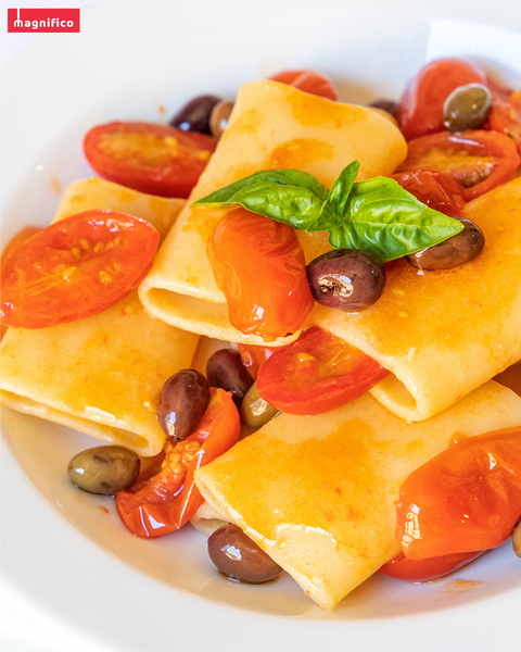 Paccheri Lisci pasta with olives, cherry tomatoes and basil